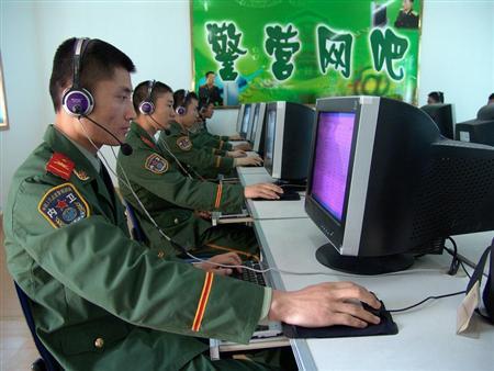 Chinese soldiers surf the Internet at an Internet bar in an army base in Huaibei, in eastern China's..